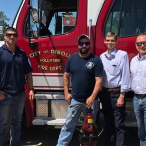volunteer firefighters, the mayor of diboll and Georgia Pacific rep standing by a fire truck