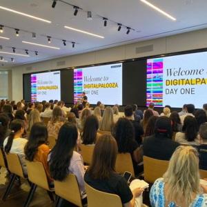 a large room of seated people "welcome to digitalpalooza" on the screen