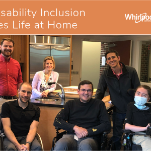 3 people stand behind 3 people in wheelchairs in a home kitchen