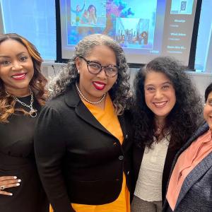 a group of four women in a conference room