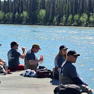 volunteers eating lunch on the dock