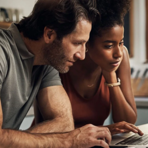 Two people looking at a laptop together