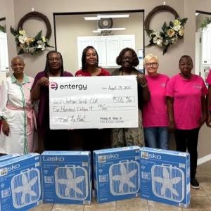 people with window fans and a donation