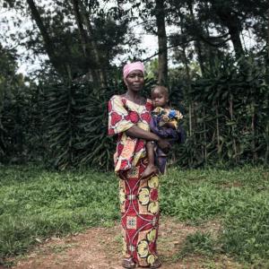 Georgine Dz'dha Nzale holds her 27-month-old son, David Wauba, who suffers from severe acute malnutrition, near the Drodro Health Center in Ituri, northeastern Democratic Republic of Congo. Here, Action Against Hunger manages treatment for severely malnourished children. 