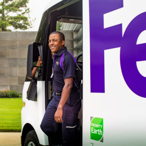 a driver steps out of a FedEx truck