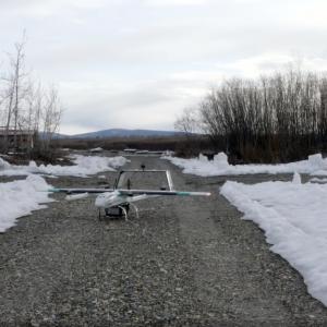 A drone on a cleared path with snow surrounding.