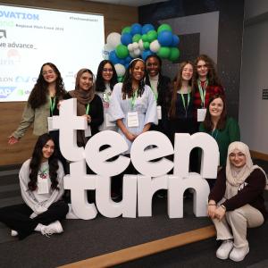 A group posing next to letters that spell "teen turn"