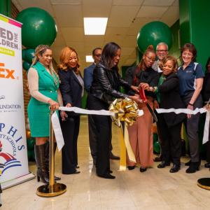 People performing a ribbon cutting ceremony