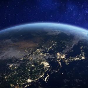 The Earth in outer space. Lights from cities visible.
