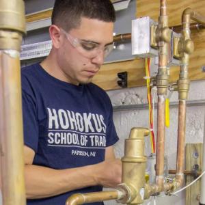 A person working on water piping.