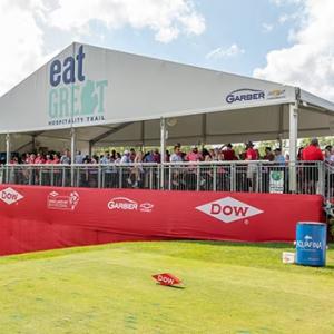 People stood watching a golf tournament