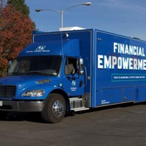 Blue semi trailer with "Financial Empowerment" on the side.