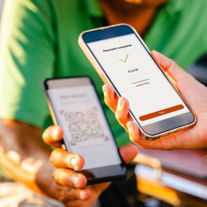 Person paying by scanning a QR code