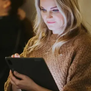 Catherine Capon using a tablet.