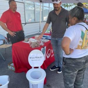 An employee showing attendees a display.