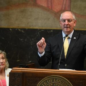 Gov. John Bel Edwards speaking at a podium