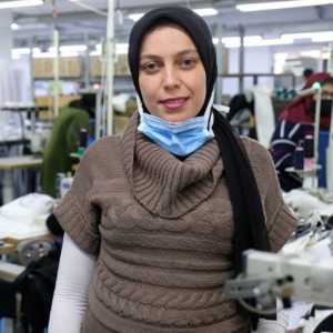 A person standing in a textile factory