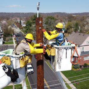 Workers up on electrical pole