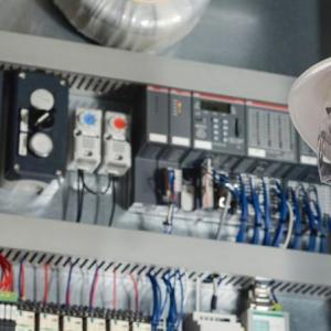 An electrician working with wires and tools.
