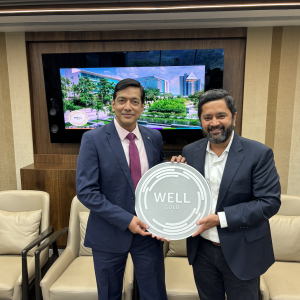 2 people hold WELL Award