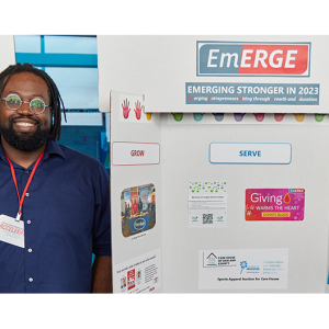 Henkel employee with an EmERGE poster