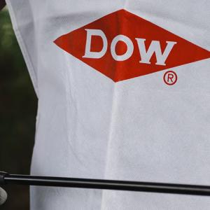 person wearing gloves and a Dow shirt