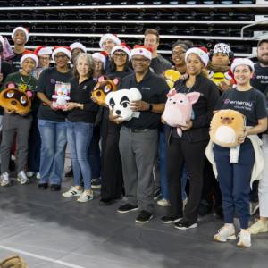 A group of people standing with toys