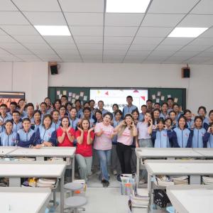Group of students posed together in a classroom