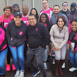 Group of people standing together in T-Mobile branded apparel