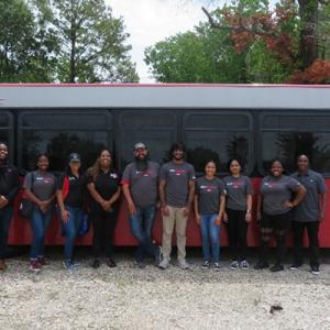 Dow team members standing in front of a bus