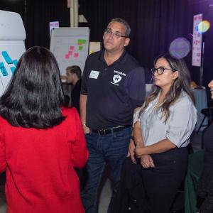 Tom Handl and three others standing by a paper flip-board