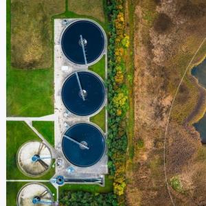 Areial view of a water treatment plant next to a water source.