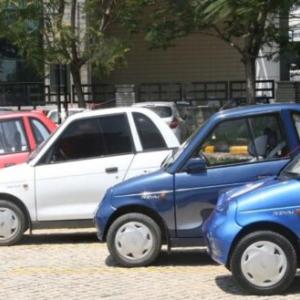 A row of small cars in a parking lot.