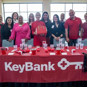People standing behind KeyBank's event booth