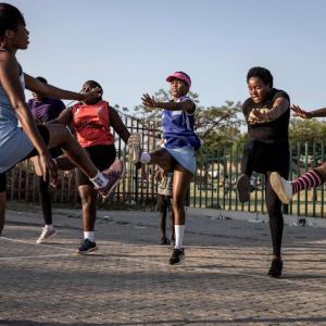 A group of people doing exercises outside.