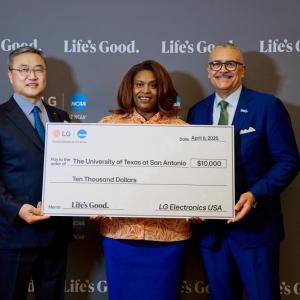 Three people posing with an oversized check