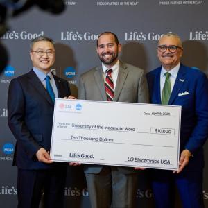 Three people posing with an oversized check