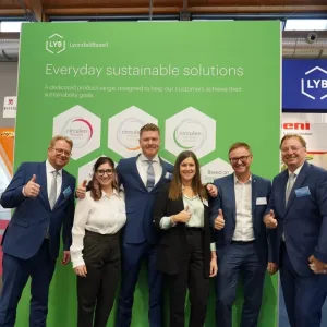 A group of people stood together in front of a LYB event backdrop 