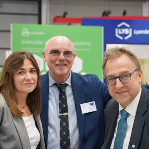 Three people stood together for a photo