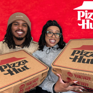 Keith Lee and his wife holding pizza hut boxes