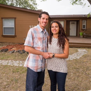 Couple standing in front of a house