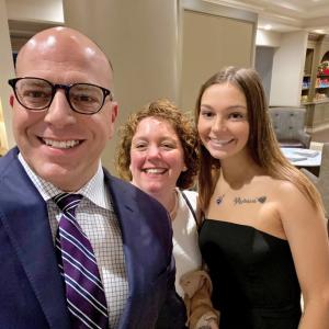 Scott, his wife and daughter taking a 'selfie' in a lobby