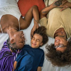 Family laying in bed
