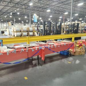 Tables decorated and food set up at the entrance to a large warehouse