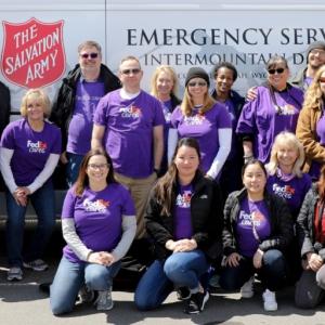 FedEx volunteers in front of a Salvation Army van