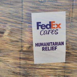 Close up of a wrapped pallet marked with "FedEx cares Humanitarian relief".