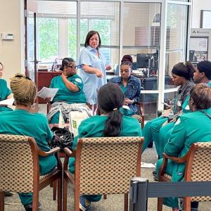 A group in a circle, seated in chairs