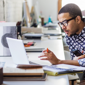A person at a desk using a laptop