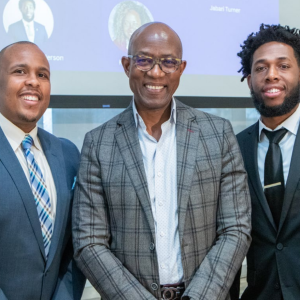 group of three black men in suits smiling