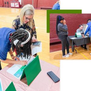 Volunteers assisting youth filling out worksheets.
